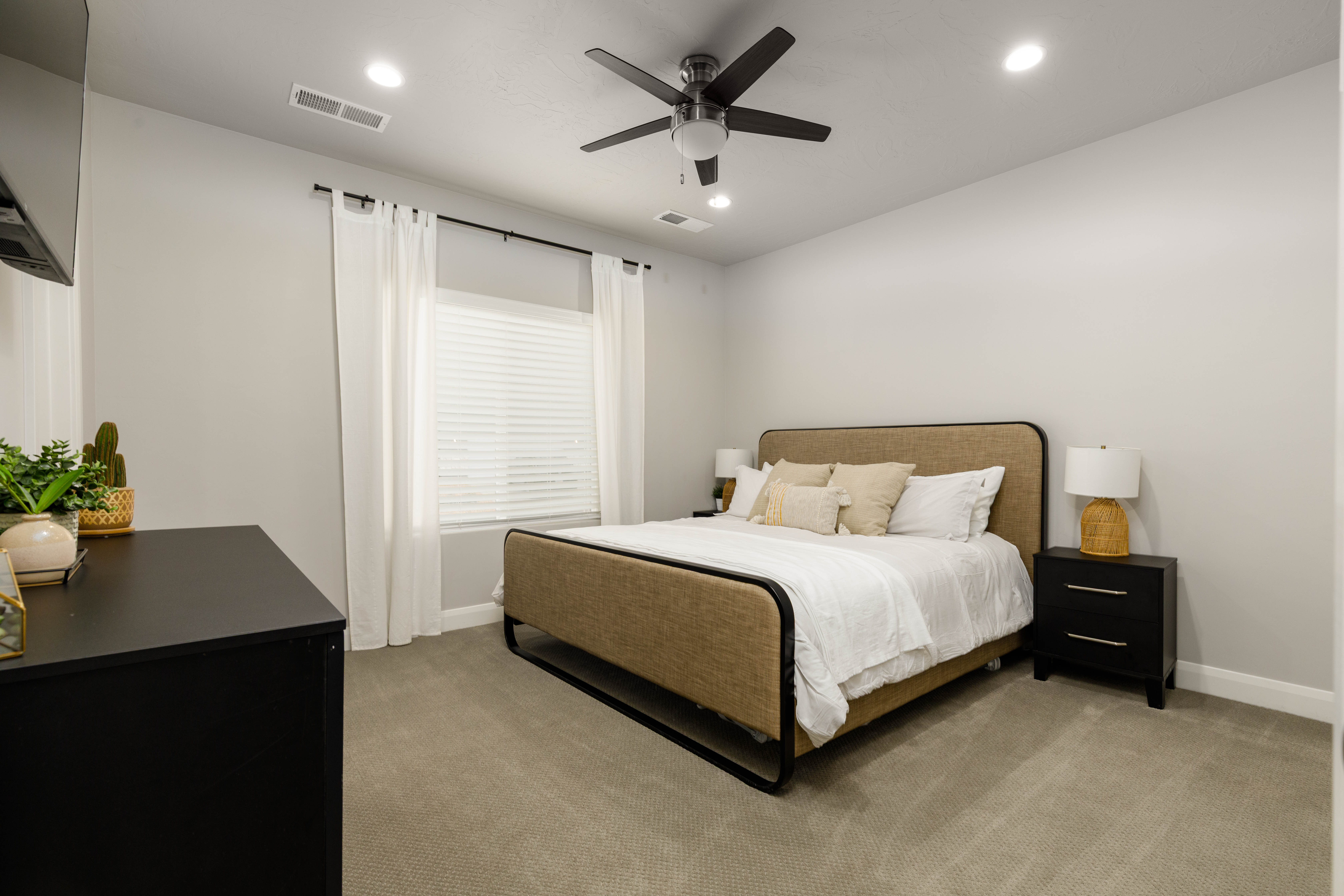 Bedroom 2 with on suite bathroom. Carpeted bedroom featuring a ceiling fan and recessed lighting