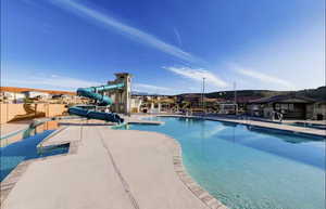 Community pool featuring a water slide and lazy river
