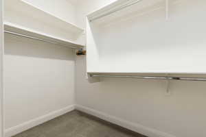 Walk in closet with light colored carpet