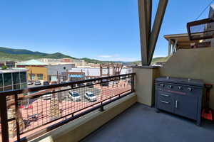 Balcony featuring a mountain view and area for grilling