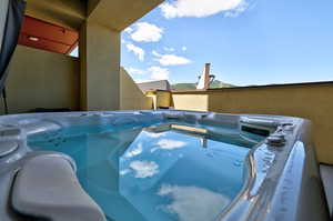 View of pool with a hot tub