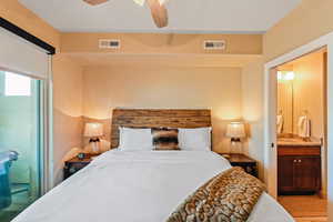 Bedroom featuring connected bathroom and a ceiling fan