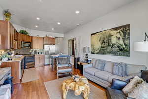 Living room featuring light wood finished floors and recessed lighting