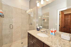 Bathroom featuring vanity and a shower stall