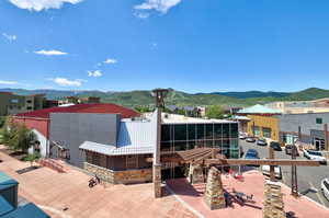 Rear view of property with a mountain view and a patio