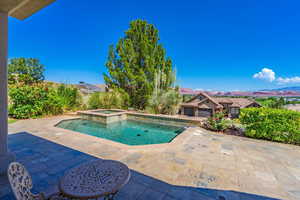 View of pool featuring a patio, a mountain view, and a pool with connected hot tub