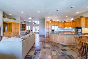 Kitchen with dark stone countertops, a large island, recessed lighting, appliances with stainless steel finishes, and a textured ceiling