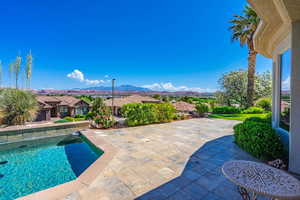 Outdoor pool featuring a mountain view, a patio, and a residential view