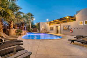 Pool at dusk with a patio area