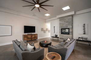 Living area featuring ceiling fan and a fireplace