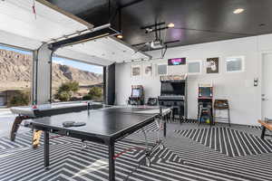 Playroom featuring a garage and a wall of windows