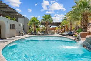 Swimming pool with a pergola and a patio area