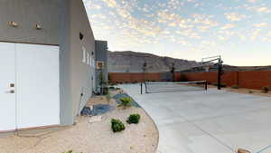Fenced backyard with a mountain view and basketball court