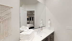 Bathroom featuring vanity and connected bathroom