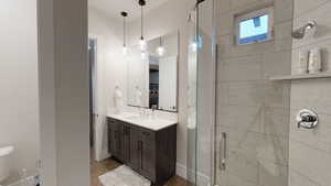 Bathroom with a stall shower and vanity