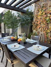 View of patio featuring outdoor dining area and a pergola