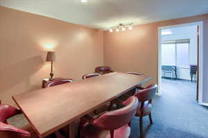 Dining room with carpet floors and a textured ceiling