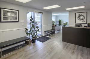 Welcome area featuring wainscoting and a drop ceiling