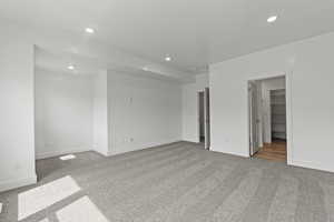 Unfurnished room with light colored carpet and recessed lighting