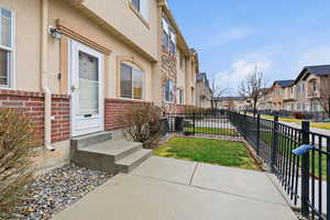 View of exterior entry featuring stucco siding and a residential view