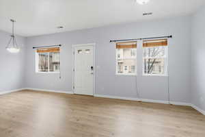 Foyer with plenty of natural light and light wood-type flooring