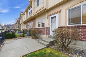 View of exterior entry featuring stucco siding and brick siding