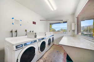 Community laundry room featuring separate washer and dryer
