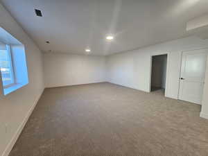 Spare room featuring carpet flooring and recessed lighting