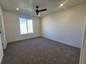 Spare room with ceiling fan, dark colored carpet, recessed lighting, and a textured ceiling