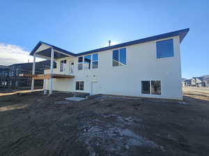 Rear view of house with stucco siding