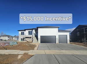 View of front facade with concrete driveway and a garage