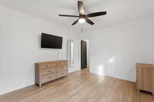 Unfurnished bedroom with a ceiling fan and light wood finished floors