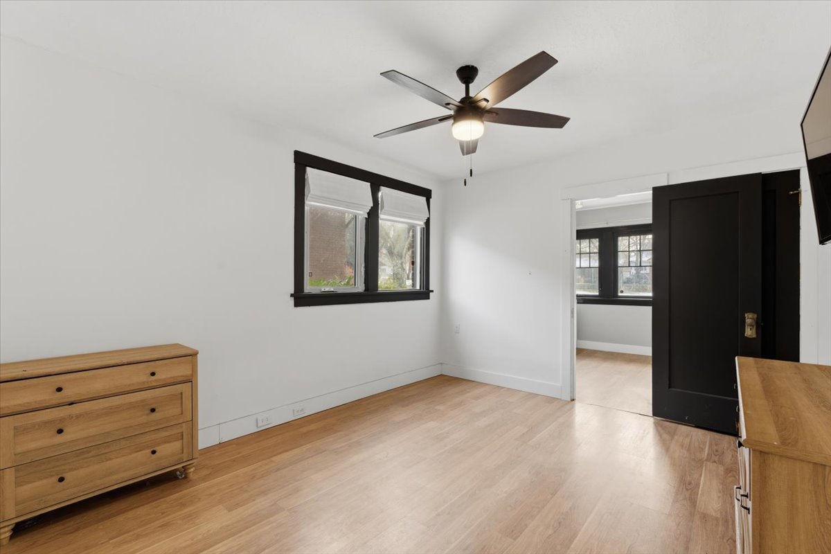 Unfurnished bedroom with ceiling fan and light wood finished floors