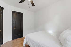Bedroom featuring wood finished floors and a ceiling fan