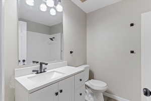 Full bath with vanity, wood finished floors, and a shower