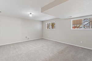 Living room with light colored carpet and a textured ceiling