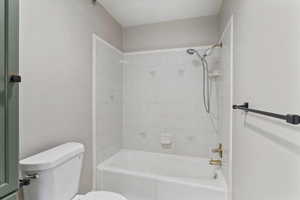 Bathroom featuring toilet and shower / bath combination