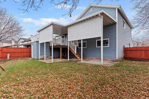 Back of house with a patio area, a fenced backyard, a deck, and stairway