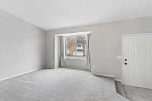 Carpeted front room with baseboards