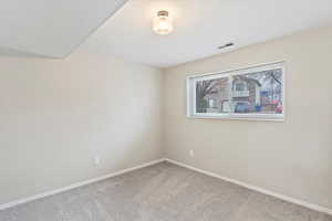 Carpeted empty room featuring baseboards