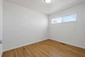 Unfurnished room with baseboards and light wood-style floors