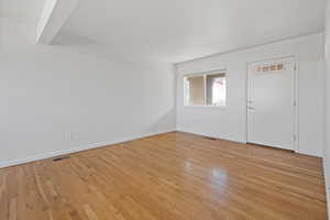 Entryway with light wood-style floors and baseboards