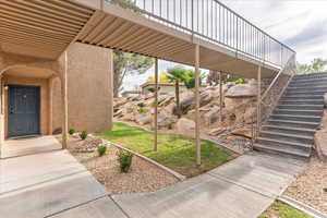 Exterior space featuring stairs and a deck