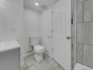 Full bathroom featuring vanity, recessed lighting, and a tub