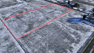 Snowy aerial view with property parcel outlined and a rural view