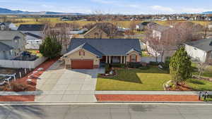 View of front of house featuring a residential view, concrete driveway, a mountain view, an attached garage, and a porch