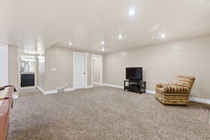 Living area with carpet and baseboards