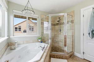 Bathroom with a jetted tub and a stall shower