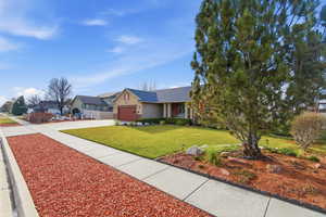 View of front of home with driveway, a garage, roof with shingles, and stucco siding