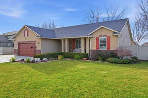 View of front of home with brick siding, roof with shingles, concrete driveway, stucco siding, and an attached garage